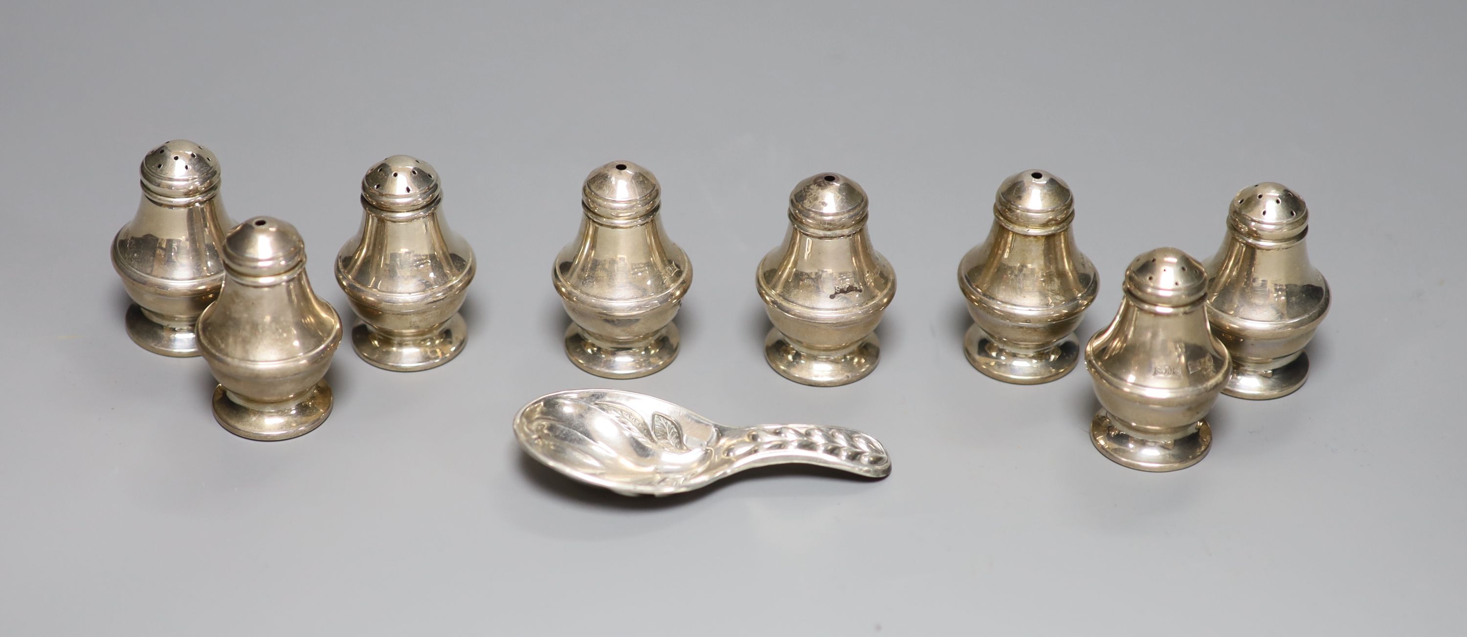 A set of eight modern silver condiments, 48mm, 89 grams and a silver plated caddy spoon.